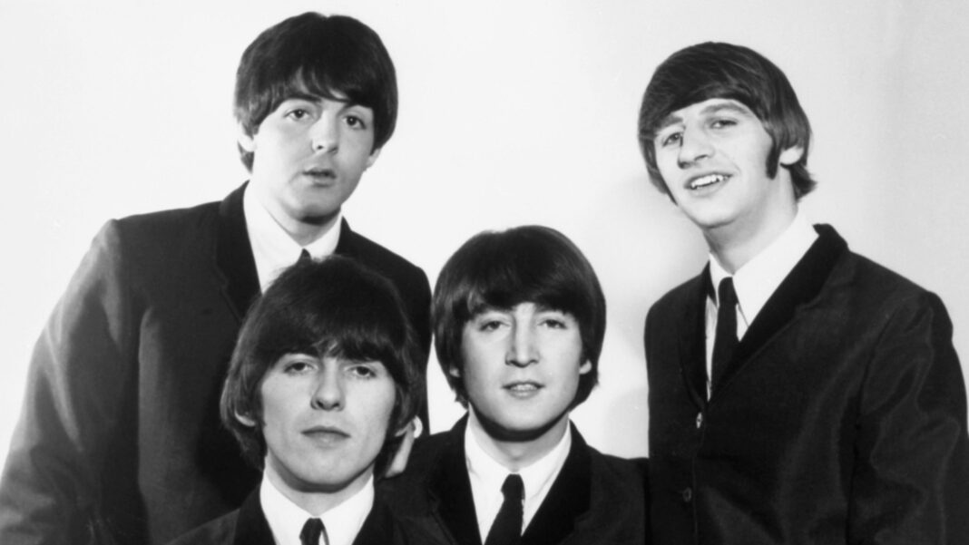 Freud confirms Beatles’ songs to star in musical A black and white staged photograph of The Beatles, looking at the camera with a white background behind them. (Left to right) the members Paul McCartney, George Harrison, John Lennon and Ringo Star are all wearing matching suit jackets, shirts and ties.