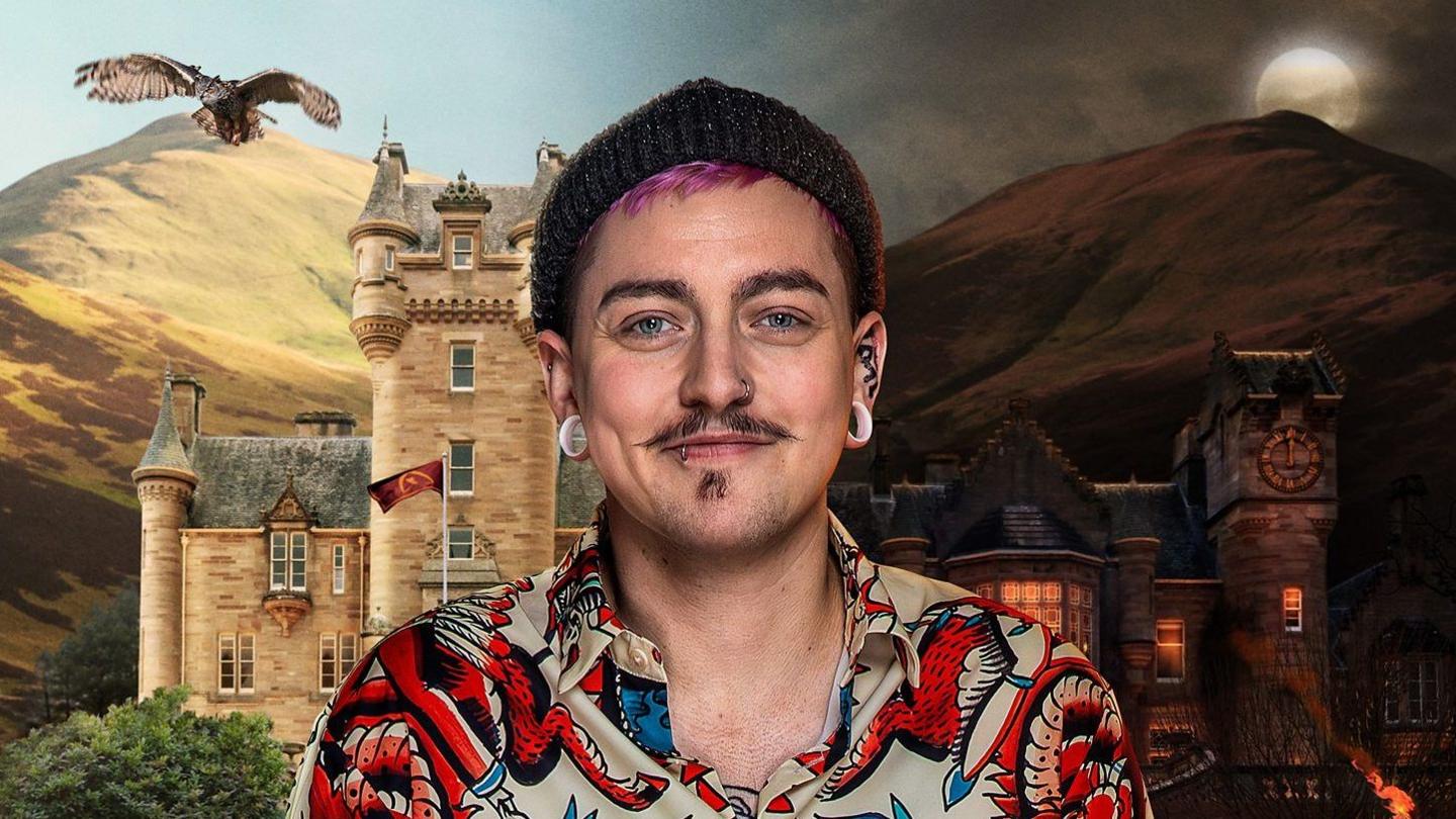 A young man with a patterned shirt is smiling at the camera