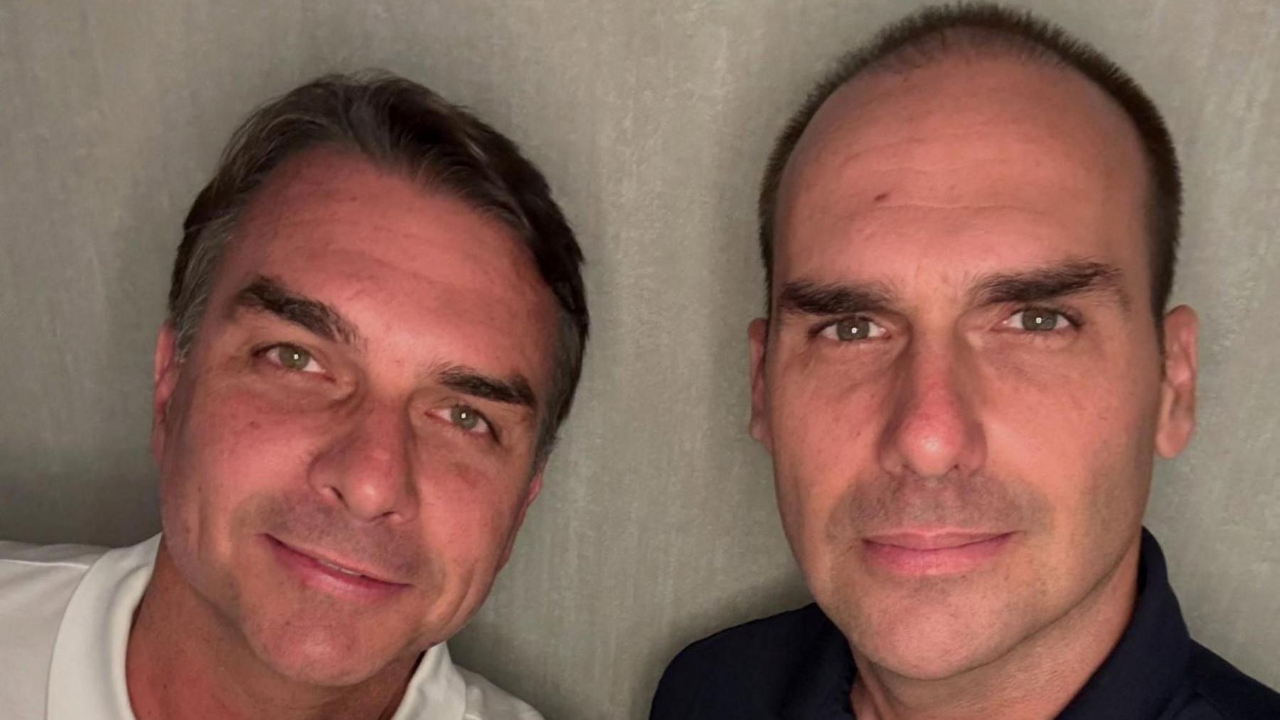 Flavio Bolsonaro  and his brother, Eduardo Bolsonaro, smile at the camera as they pose at an unidentified location, in this picture obtained from social media and released on October 28, 2026.