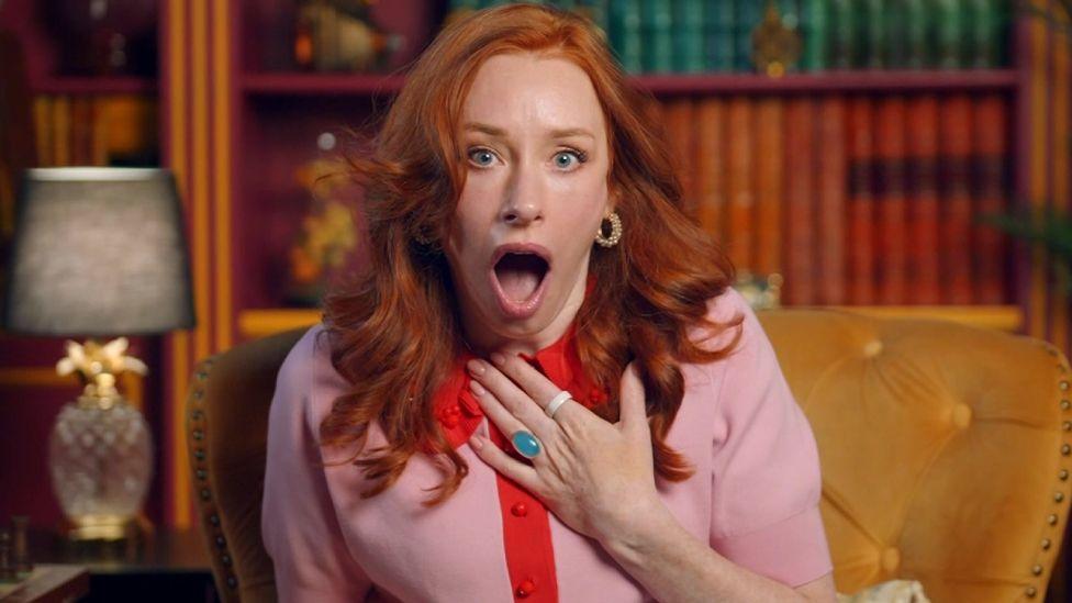 Hannah Fry looking shocked, with her hand to her chest in the castle diary room, in Celebrity Traitors