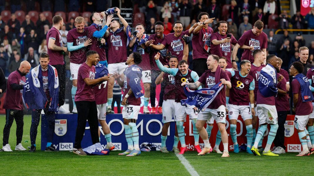 Failure on the field, unrest in stands – Burnley’s horror 12 months Burnley players celebrate winning promotion to the Premier League in 2025 by swigging from bottles of champagne and wearing claret t-shirts with Premier League written on the them