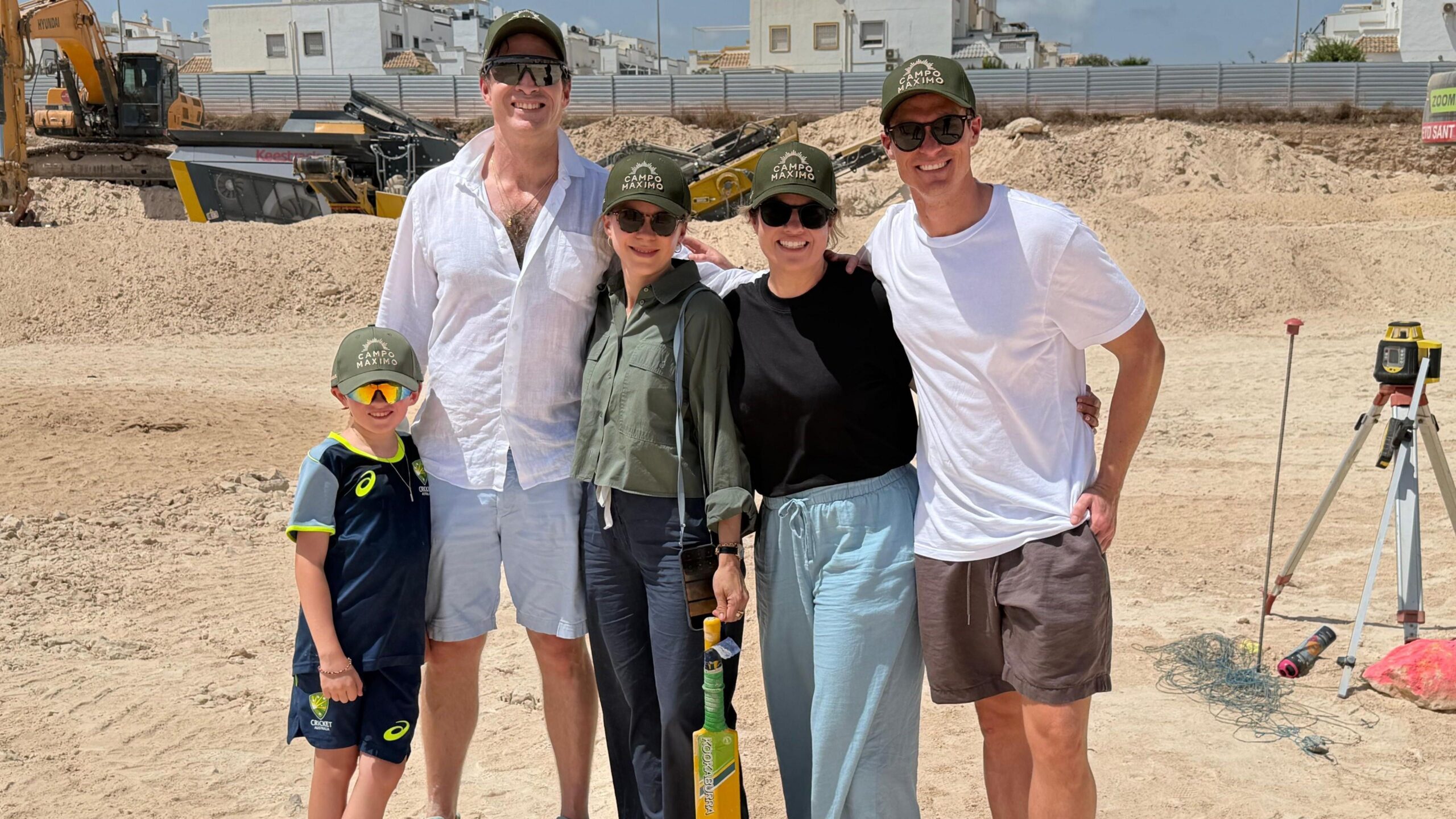 Daniel Weston and his family holding a cricket bat while ground is broken at Campo Maximo
