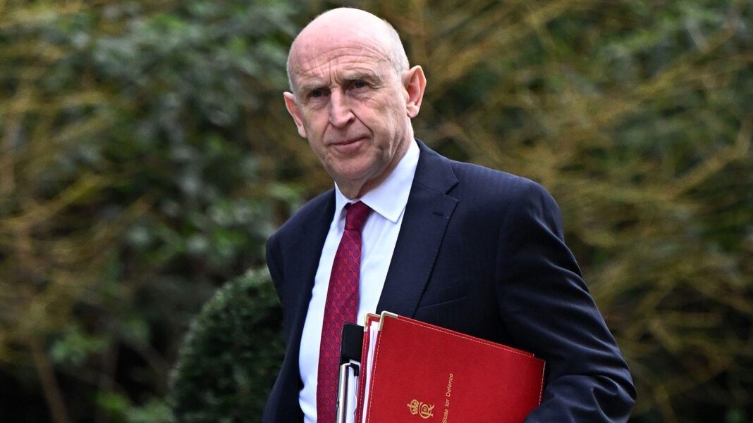 Healey faces £35bn Budget challenge to meet spending pledges, says think tank John Healey walks along Downing Street with files under his arm wearing a dark suit and a long red tie.