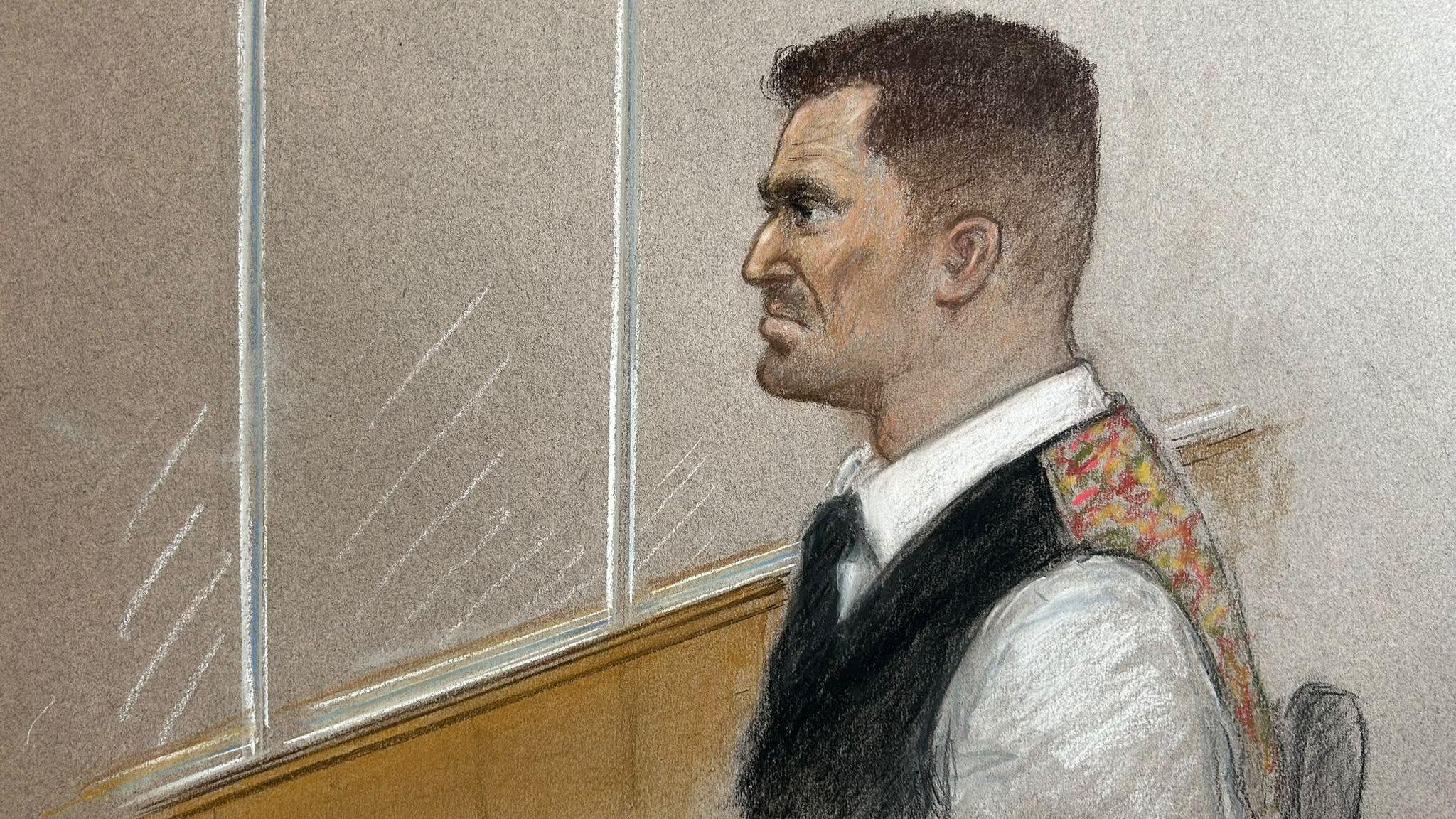 A court sketch of Stephen Yaxley-Lennon sitting in the dock, seen in profile. He wears a white shirt and black tie, with a black waistcoat that has a colourful back.