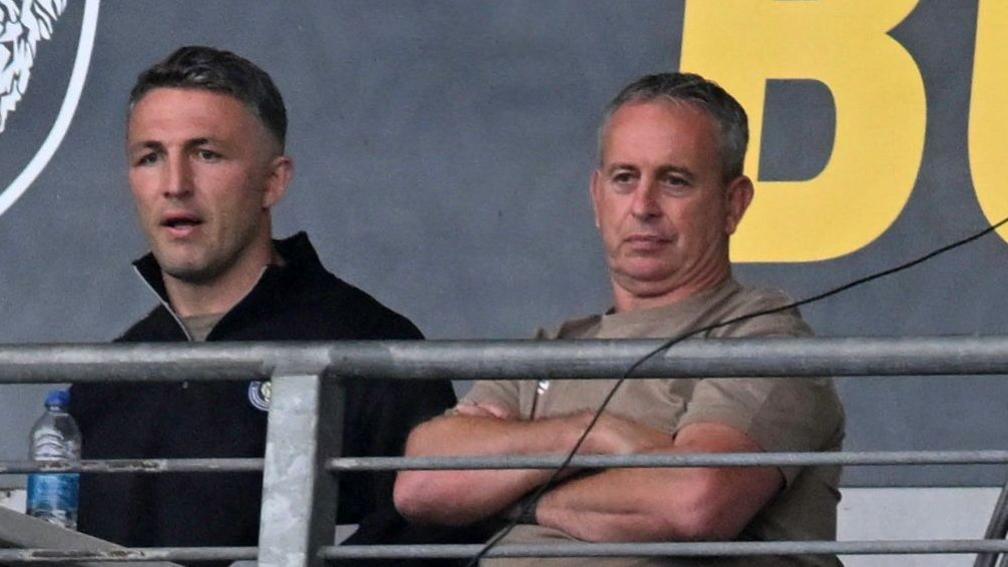 Sam Burgess (left) and Steve McNamara (right) watch Warrington against Hull FC earlier this season