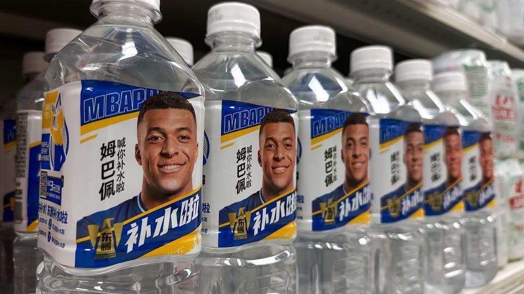 Bottles of Dongpeng Bushuila electrolyte beverages produced by Eastroc Beverage featuring images of French footballer and brand ambassador Kylian Mbappe
