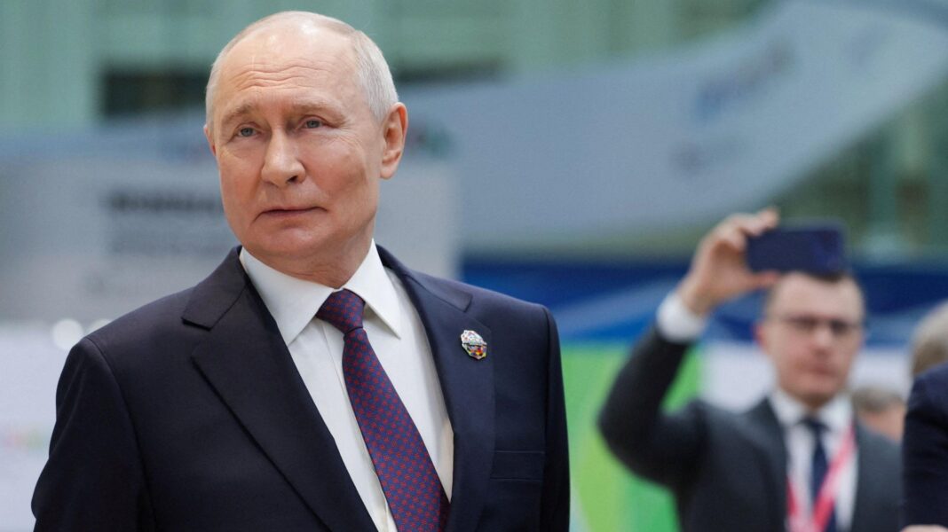 Russian President Vladimir Putin looking to the side as he stands during a presentation of Russian technology at the Russia-Africa Summit.
