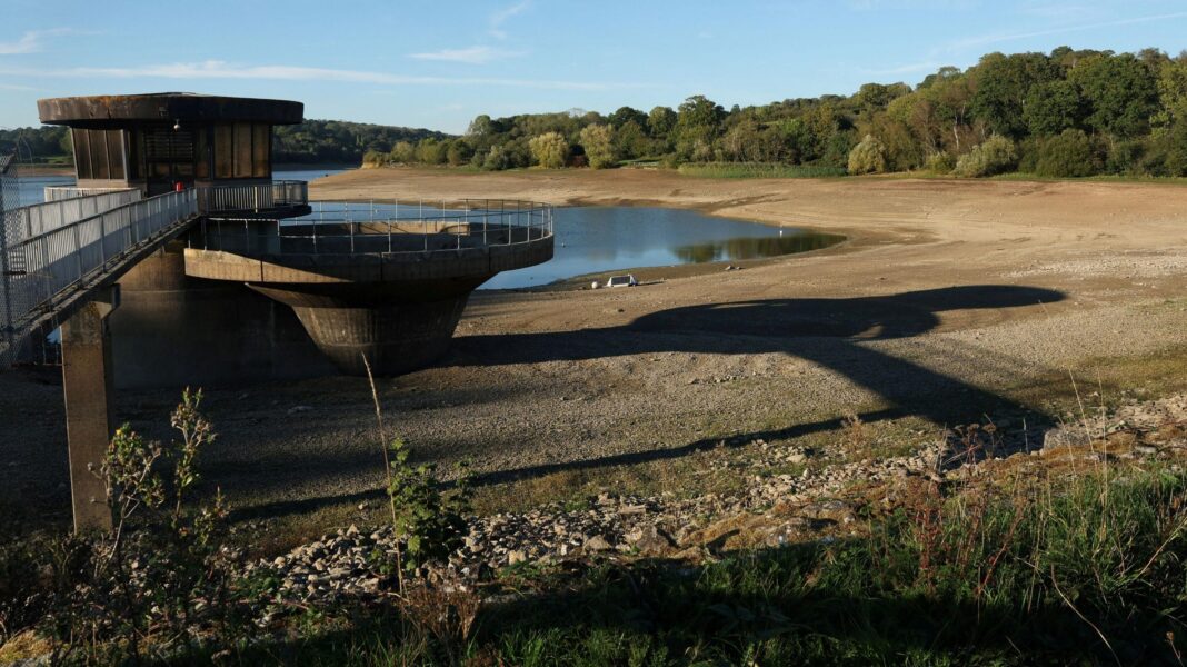 Severe drought declared in parts of southern England Ardingly reservoir with muddy banks and concrete platform and low water.