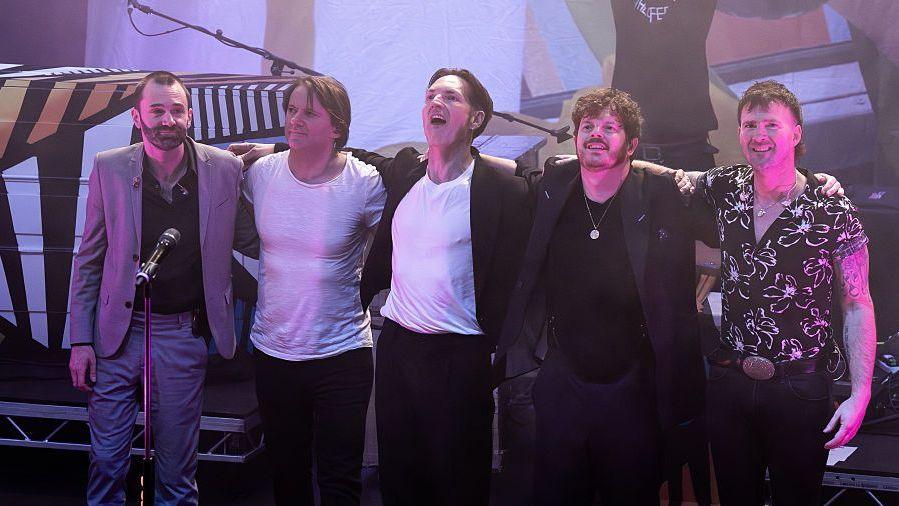Ciaran Jeremiah, Kevin Jeremiah, Dan Gillespie Sells, Richard Jones and Paul Stewart seen on stage taking a bow at end of The Feeling concert