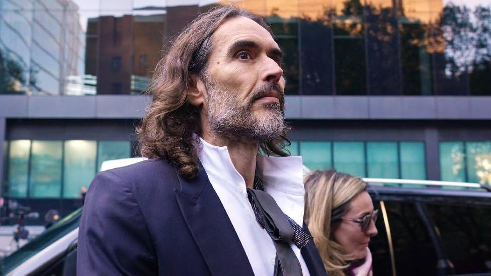 Russell Brand and wife Laura Brand arrive at court ahead of his trial, where he faces rape and sexual assault charges at Southwark Crown Court on October 28, 2026 in London, England. Russell Brand has been charged with three counts of rape, three counts of sexual assault and one count of indecent assault. He has denied all charges
