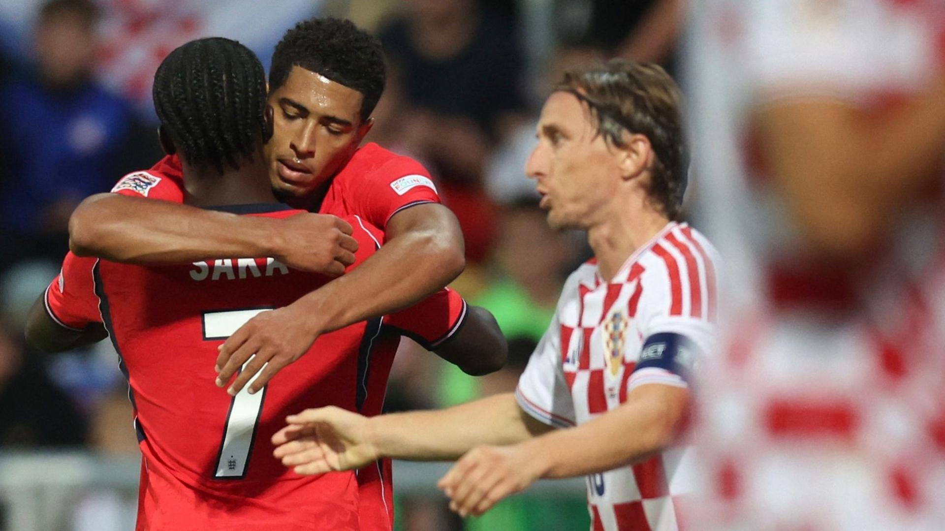 Croatia captain Luka Modric next to England's Jude Bellingham and Bukayo Saka as they celebrate a goal
