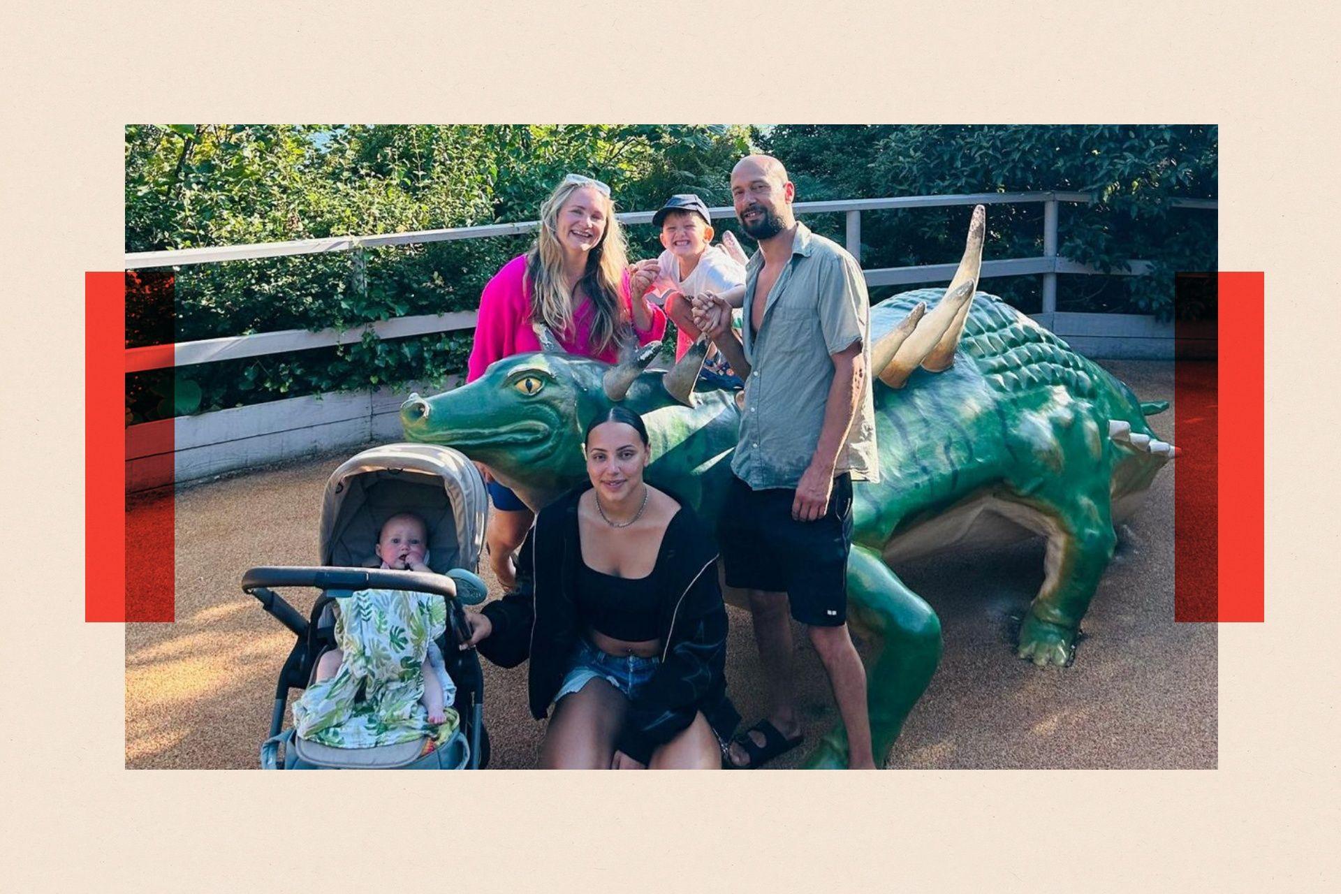 Aymara Lamche-Brennan poses with her family in front of a large fake lizard