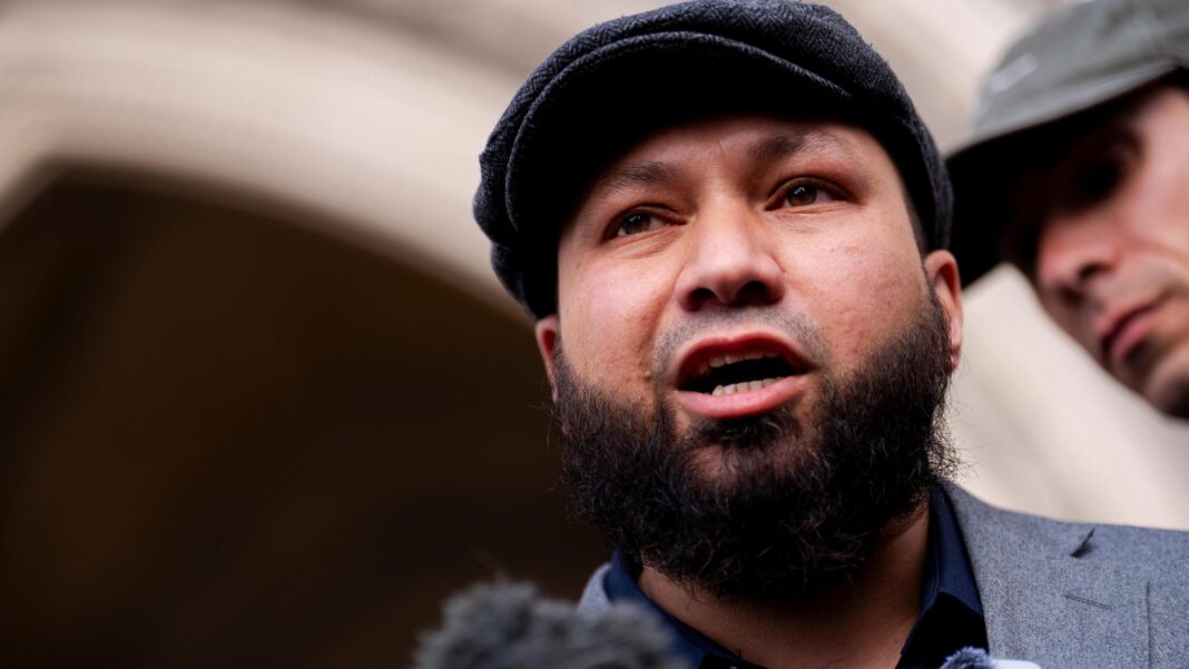 Damages for Greens deputy over false disorder claims A man wearing a flat cap stands outside a court building and addresses members of the press.