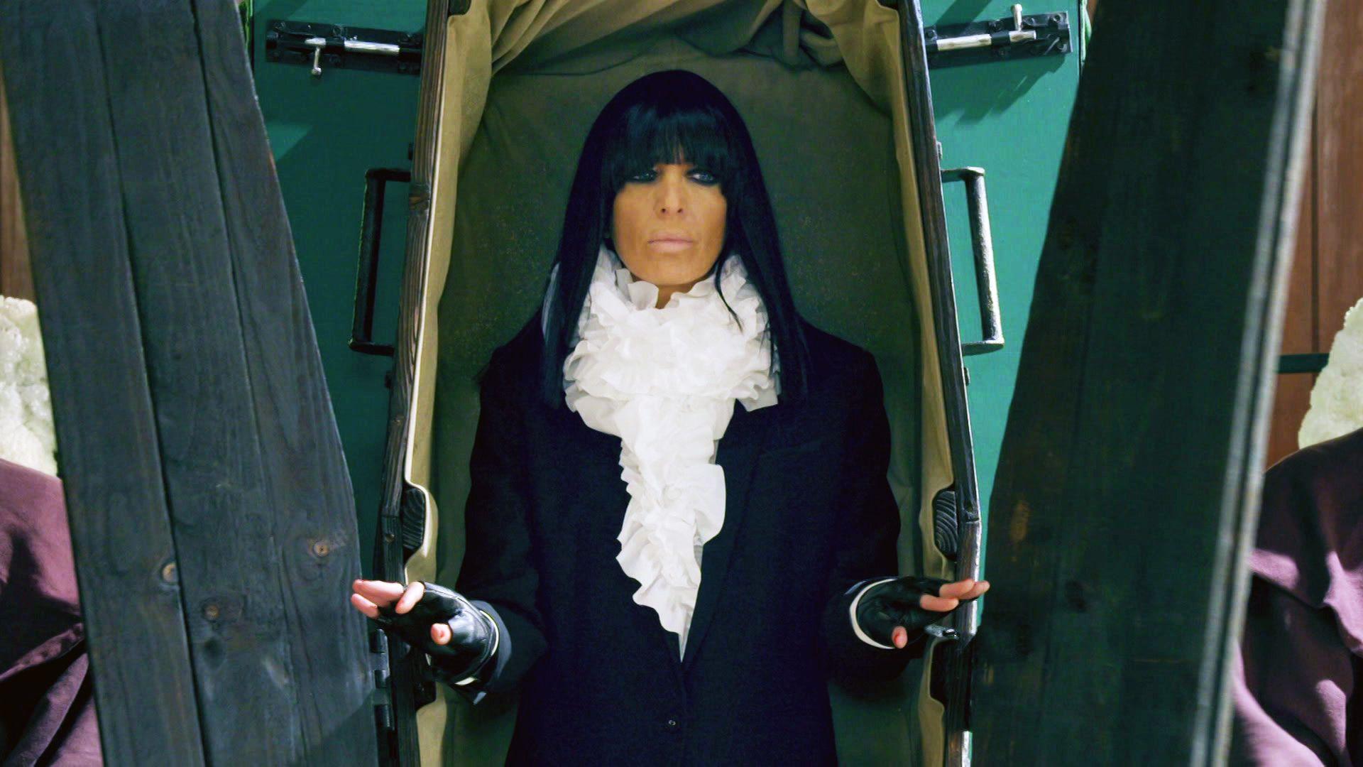Claudia Winkleman emerging from a coffin