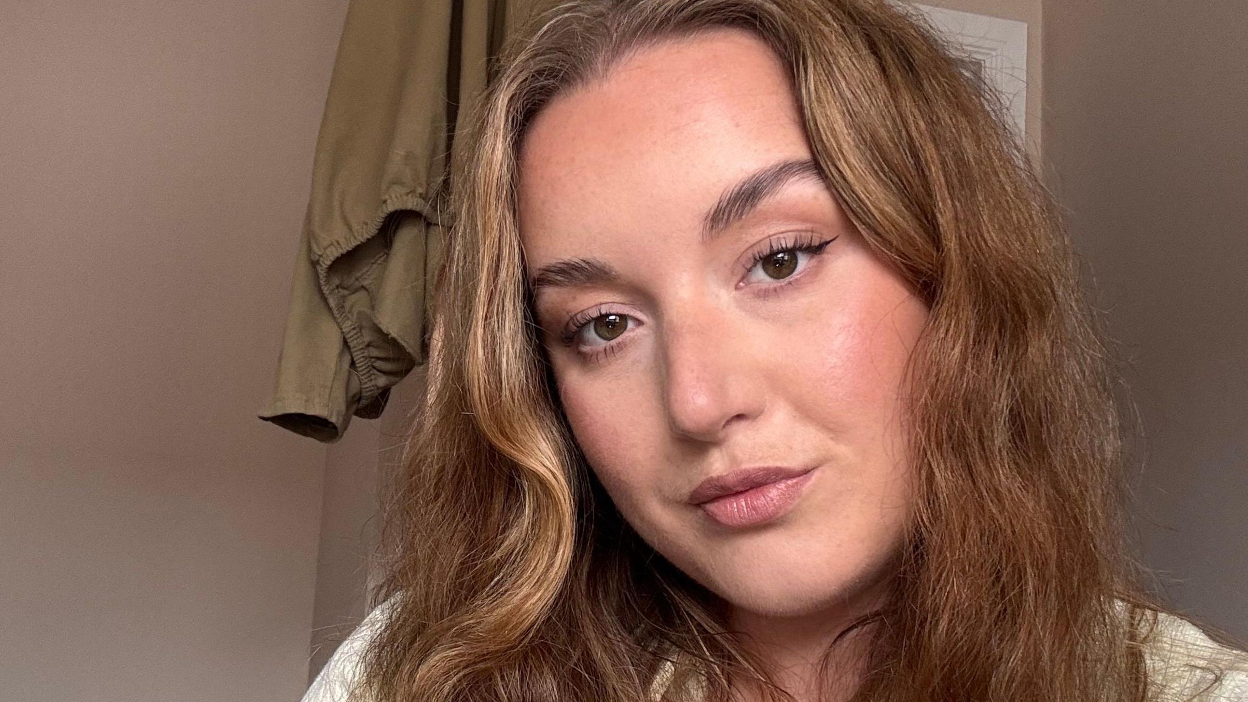 Jodie looks directly at the camera as she takes a selfie.