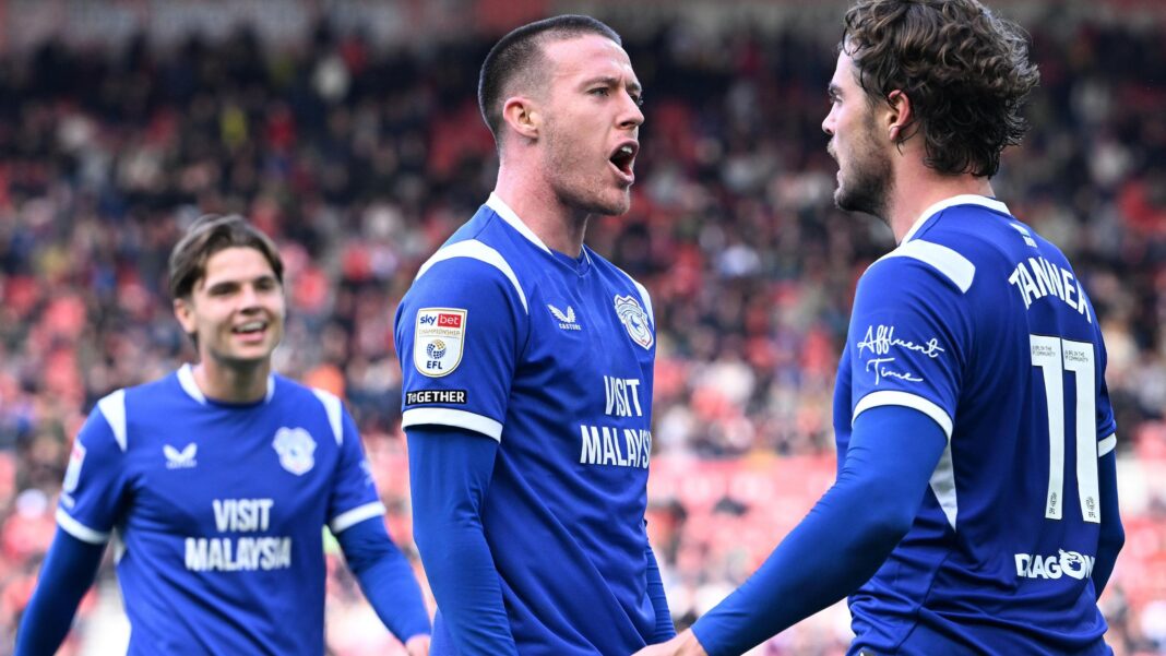 Jack Moylan and Ollie Tanner, wearing Cardiff City's blue shirts, celebrate a goal together at Middlesbrough