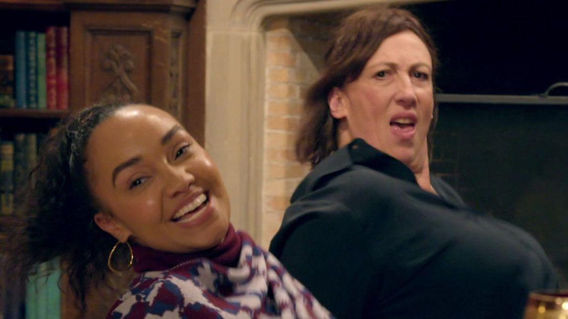 Leigh-Anne and Miranda sitting on the floor and leaning backwards in the middle of a dance move