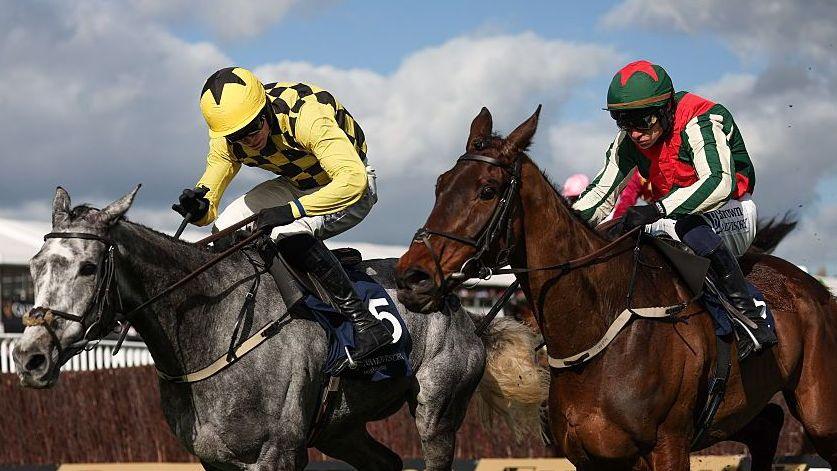 Kitzbuhel, with Harry Cobden up, left, races alongside Final Demand, with Paul Townend up, who finished second, on their way to winning the Brown Advisory Novices' Chase