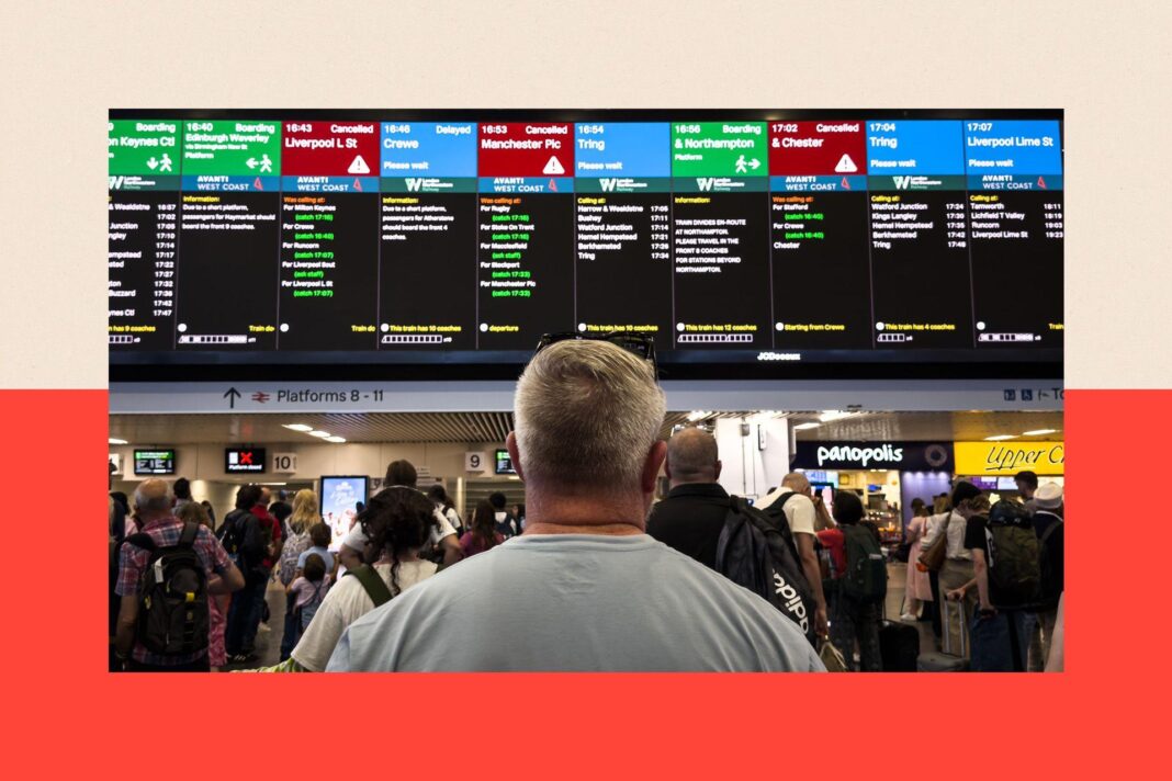 Passengers at London's Euston station look towards departure boards as trains are cancelled and delayed after a major disruption to rail service in the Midlands and north-west England in August 2026. The rear of a man's head and shoulders are visible in the foreground.