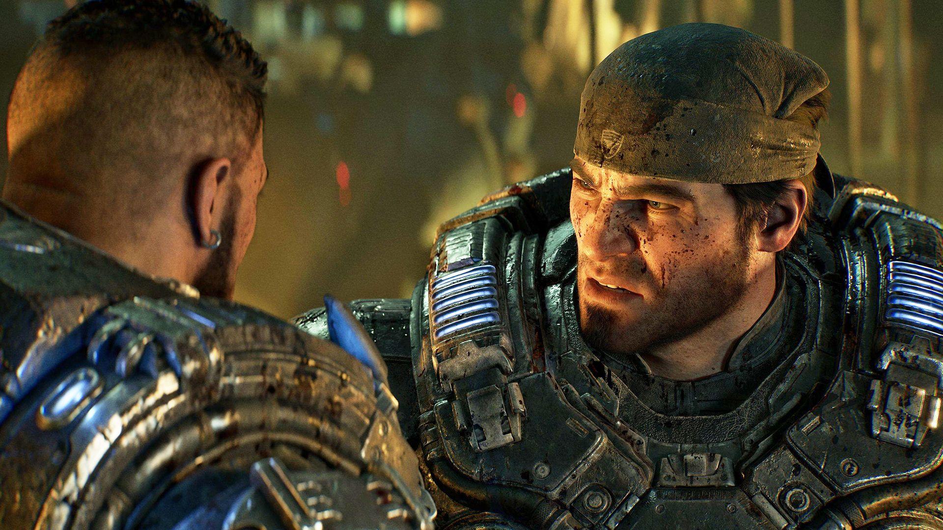 Gears of War character Marcus Fenix wears a bandanna and heavy futuristic armour. The CGI character has a cropped beard and blood-spattered face and looks seriously at another of the game's characters, seen from behind.