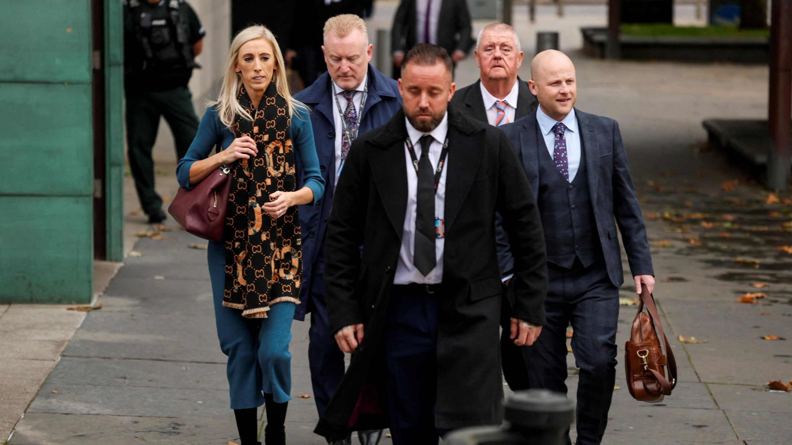 A group of men and one woman walking