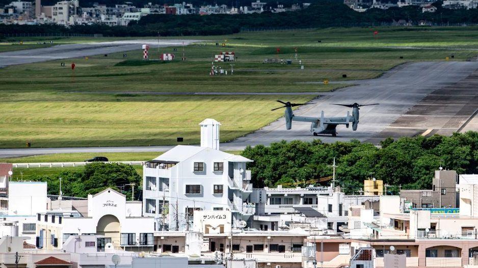 This photo taken on August 23, 2022 shows a US military Osprey aircraft (R) at the US Marine Corps Air Station Futenma in the centre of the city of Ginowan, Okinawa prefecture.