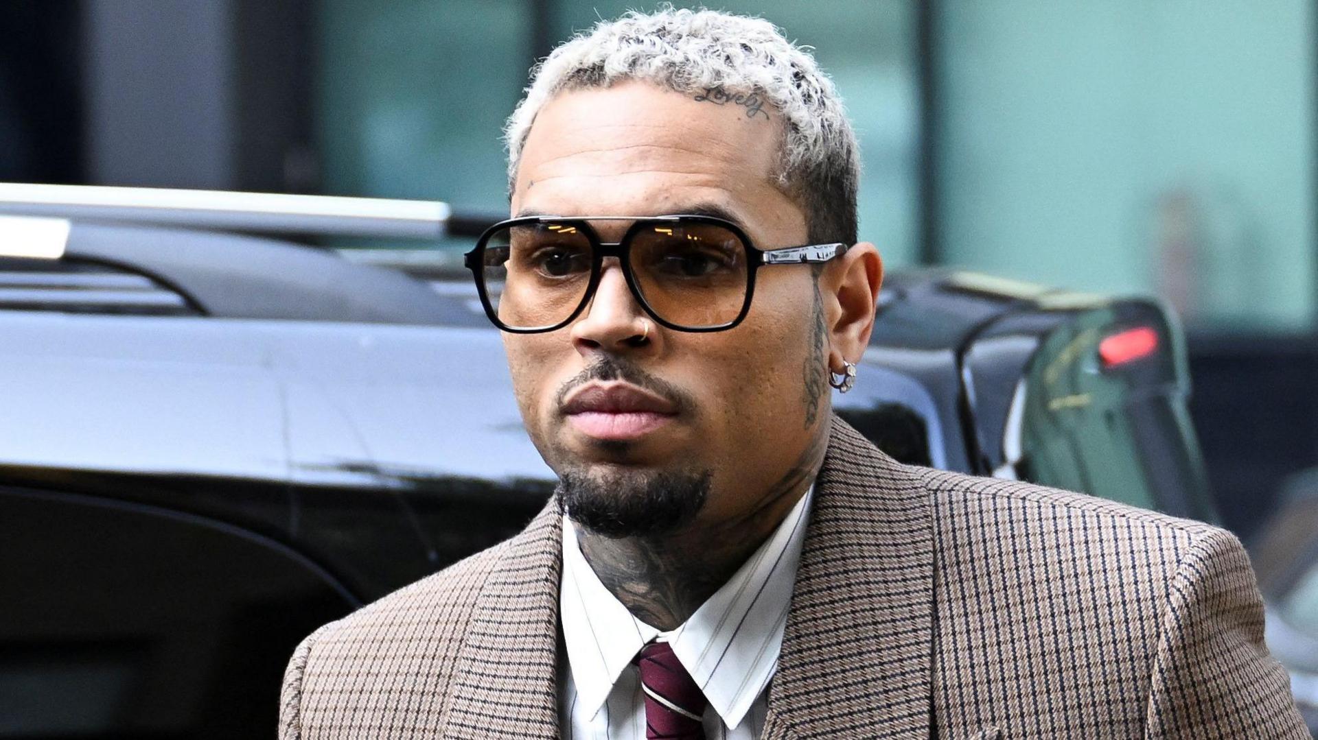 U.S. singer Chris Brown, who has been charged with inflicting grievous bodily harm in what prosecutors said was an "unprovoked attack" on a music producer at the Tape nightclub in central London in 2023, walks outside the Southwark Crown Court in London, Britain, July 11, 2025.