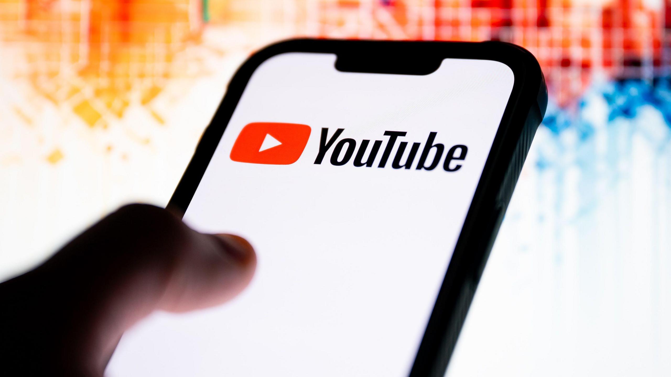 In this photo illustration, a YouTube logo seen displayed on a smartphone.
