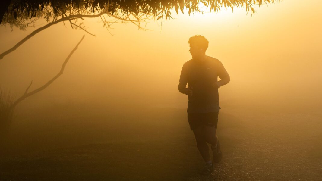 Weekend showers and sunshine for UK ahead of warmer temperatures next week A jogger runs through fog on an early October dawn