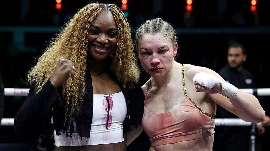 Claressa Shields and Lauren Price pose for pictures in the boxing ring