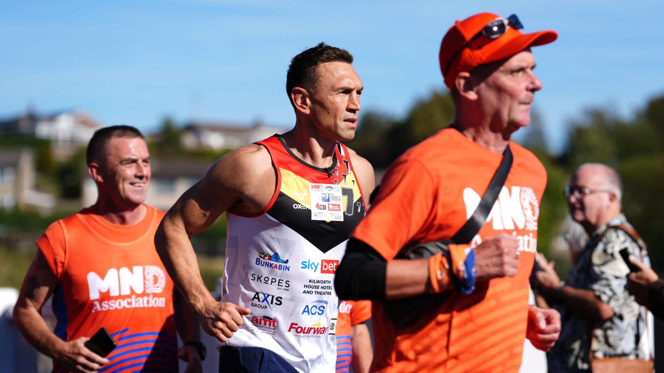 Sir Kevin Sinfield with two other men running