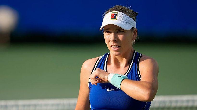 Katie Boulter, wearing a blue dress and white visor