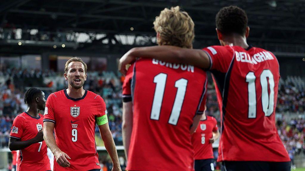 Harry Kane, Anthony Gordon and Jude Bellingham celebrate an England goal.