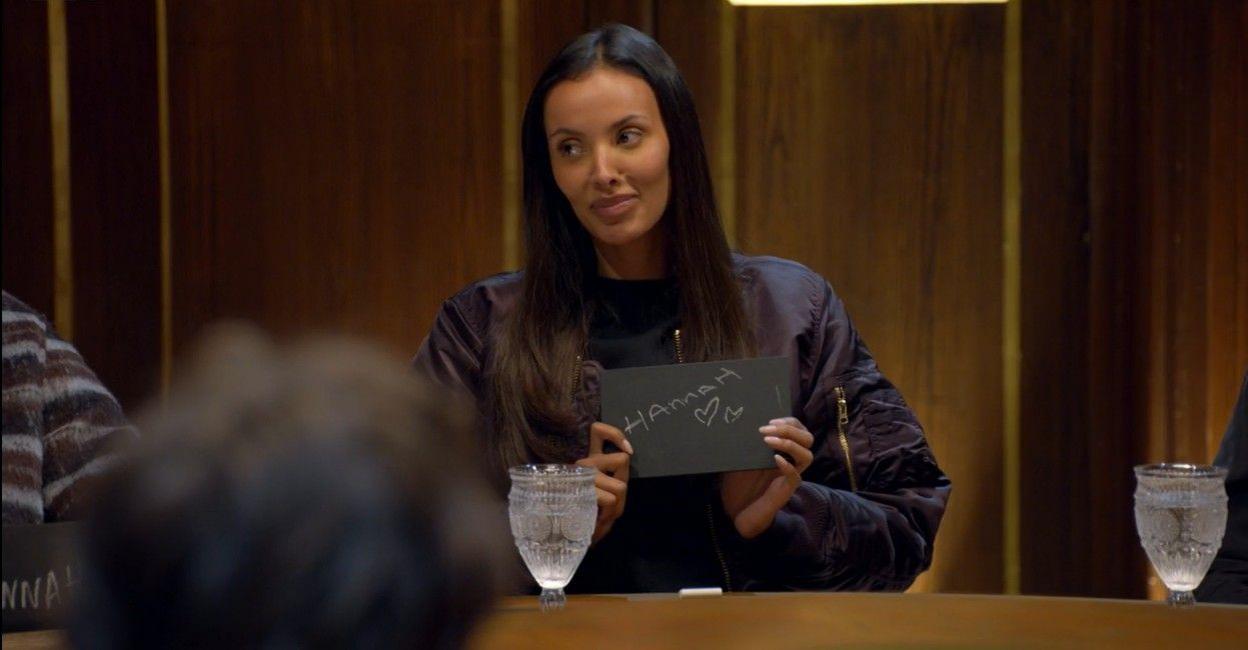 Maya Jama holding her slate, on which she has written Hannah