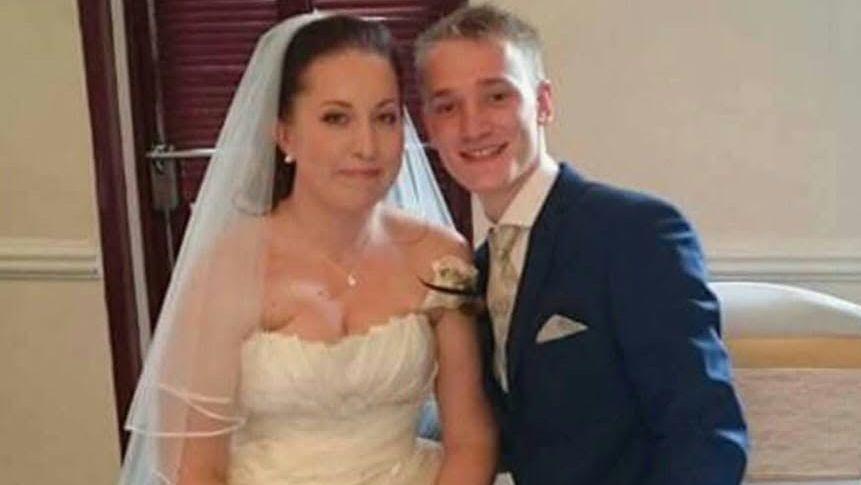 A couple pictured on their wedding day