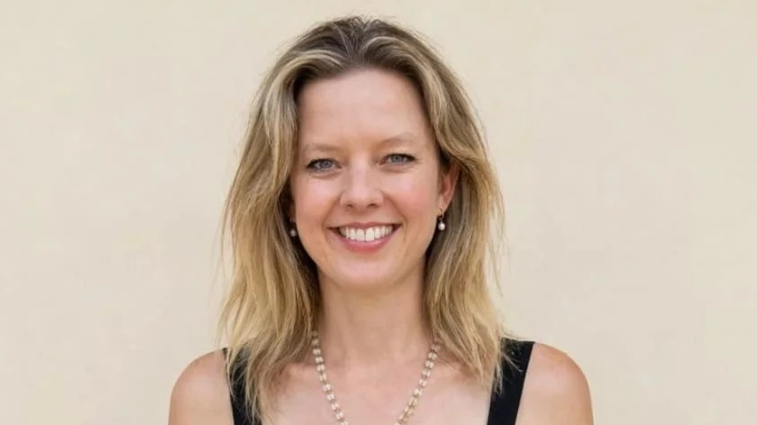 Dr Hannah Terry smiles at the camera. She has blonde hair and is wearing a black dress.