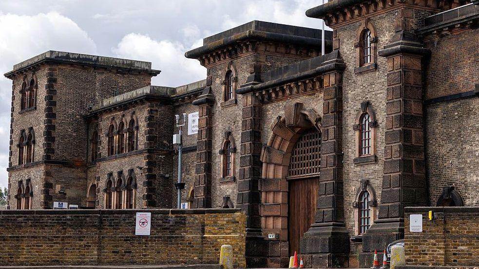 A view of HMP Wandsworth from outside the entrance on a grey, cloudy day.