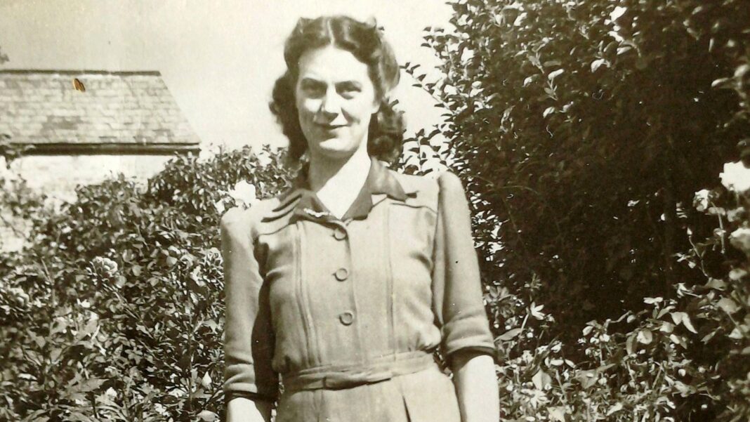 Nurse stole £750k from 99-year-old woman for cosmetic surgery and home improvements A black and white photo of a woman smiling at the camera in front of bushes