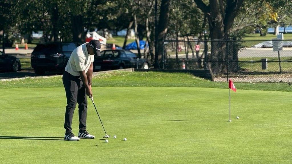 Jourdain Yardan hits a bit at a hole on East Potomac Golf Links