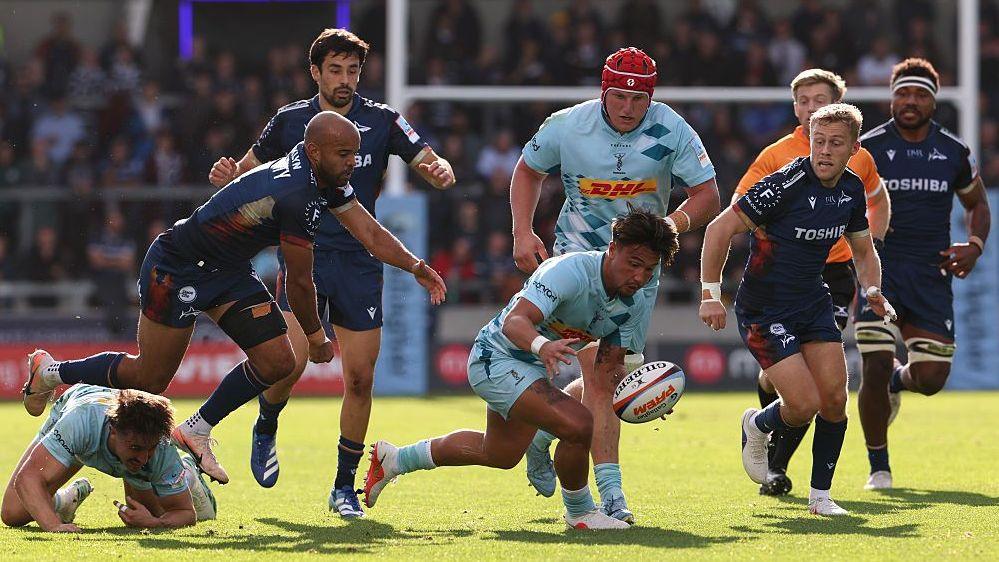 Marcus Smith pounces on a loose ball as Sale's Tom O'Flaherty and Gus Warr close in