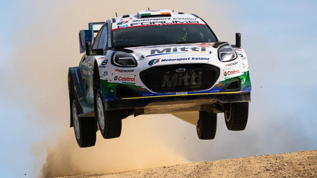 Evans claims dramatic WRC title after Solberg crash Jon Armstrong's Ford Puma takes to the air on a dusty gravel road