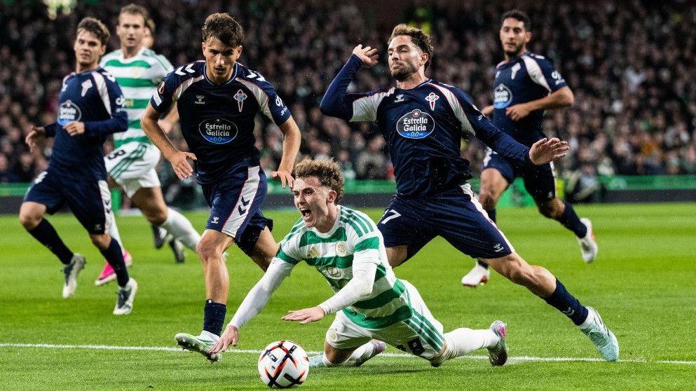 Callum Osmand of Celtic goes down under a Celta Vigo challenge