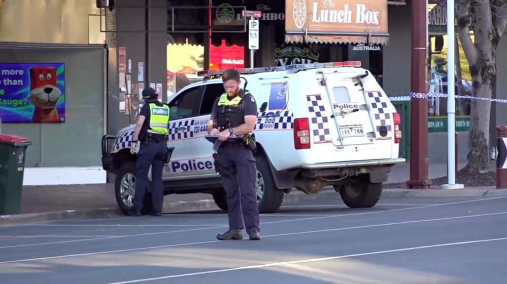 Members of the police stand guard near the scene of the vehicle incidennt involving Australian lawmaker Helen Haines in Wangaratta
