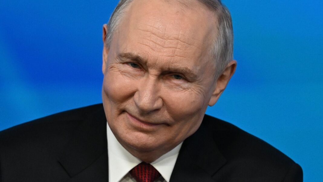 Putin warns West that Russia is ready to use every weapon to protect Kaliningrad Close up of Vladimir Putin while speaking to an audience at the Valdai foreign policy forum. He has short grey hair and is wearing a black suit, white shirt and red tie.