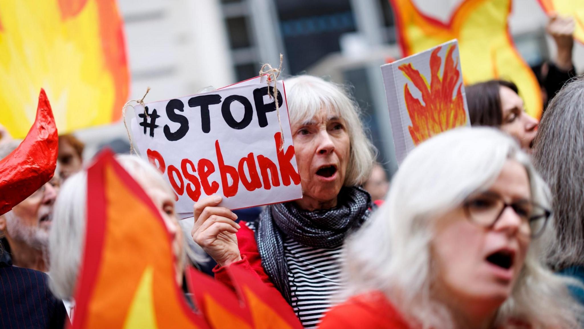 Climate protesters hold placards during a protest against the planned Rosebank oil and gas field outside the Department for Energy Security and Net Zero