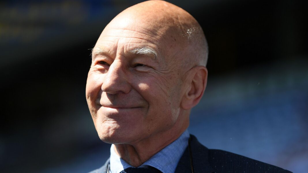 Sir Ian McKellen leads tributes to ‘beloved actor’ Sir Patrick Stewart after his death at 86 Sir Patrick Stewart smiles at the camera. He is wearing a dark suit and blue shirt, with a dark tie.
