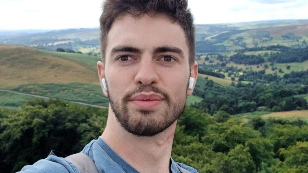 Man killed by tiger climbed two fences before suffering multiple injuries, inquest hears A selfie of William Chapman outdoors, with rolling hills, woodland and patchwork fields stretching across the landscape behind him. He is wearing wireless earbuds and is standing in front of a panoramic countryside view under a bright, cloudy sky.