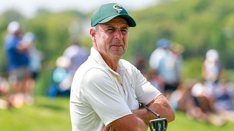 Richard Bland stands with his arms crossed on the golf course