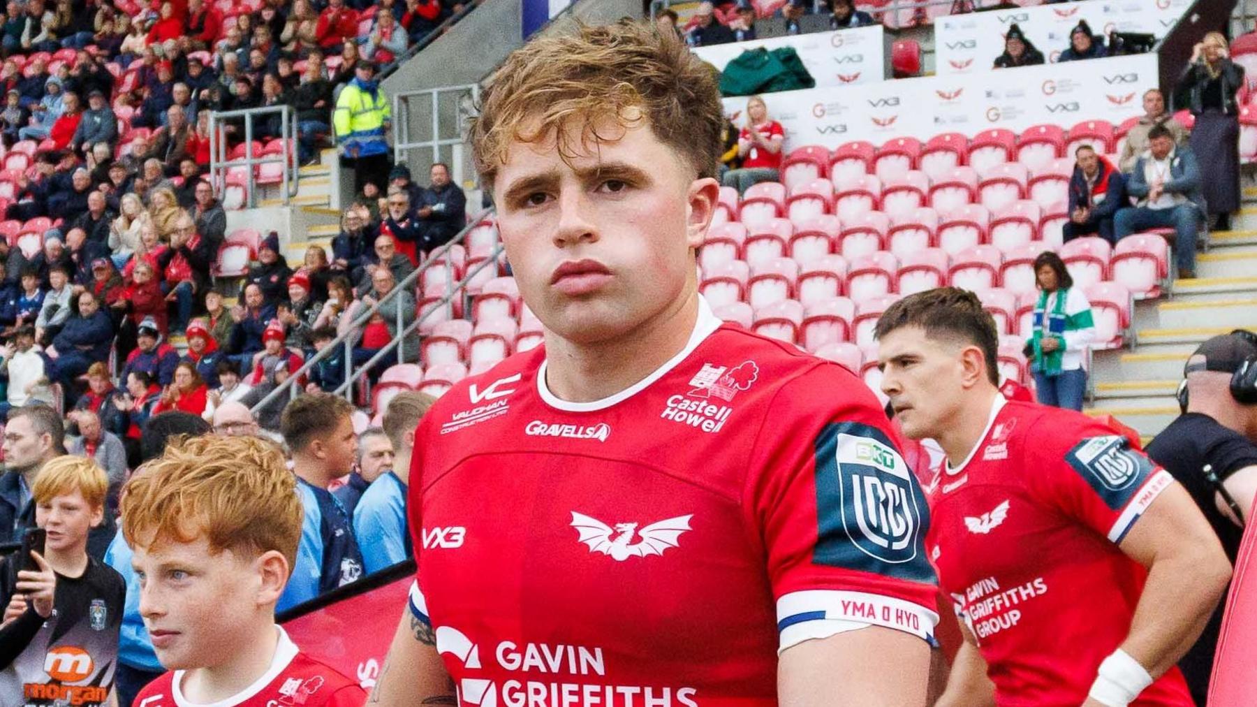 Macs Page pictured walking out for Scarlets at Parc y Scarlets