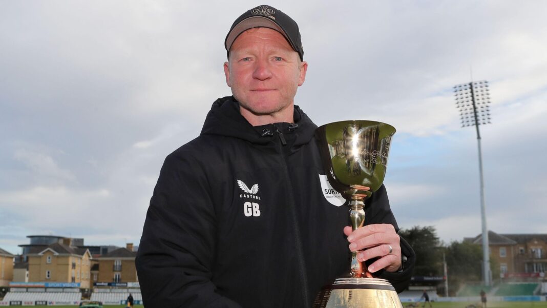 Gareth Batty in Surrey hoodie holding the County Championship trophy